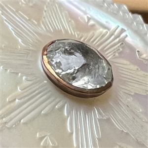 An 18th c. carved mother of pearl button with faceted paste center.
