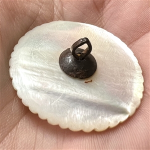 An 18th c. carved mother of pearl button with faceted paste center.