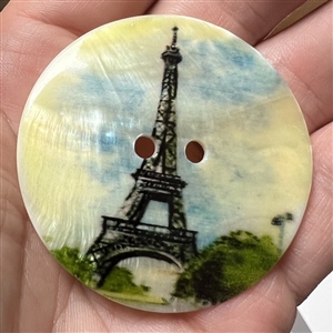 Transfer on iridescent shell button of Eiffel Tower.