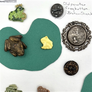 Card of twenty eight frog buttons.