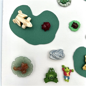 Card of twenty eight frog buttons.