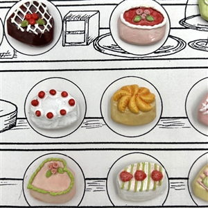 Card of twenty one ceramic buttons of bakery items.