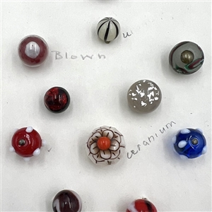 Card of forty one glass ball and modified ball buttons. 