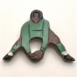 Wooden button of a soccer player.