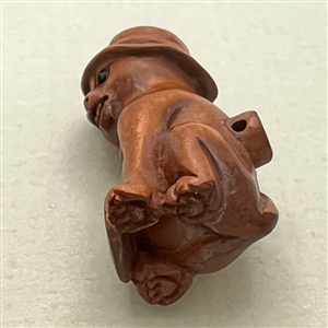 Boxwood button of cool cat in a hat.
