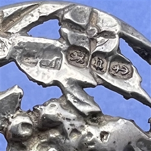 Hallmarked openwork silver button of a fairy face in garden.