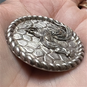 White metal button of a rooster.