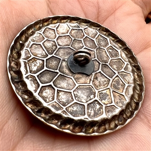White metal button of a rooster.