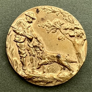 Stamped brass button of a hunter and his dog. 