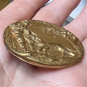 Stamped brass button of a hunter and his dog. 
