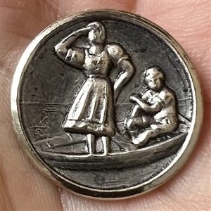Stamped white metal button of a woman standing in a boat with a man.