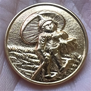 Stamped yellow metal button of a gnome with a toadstool as umbrella.