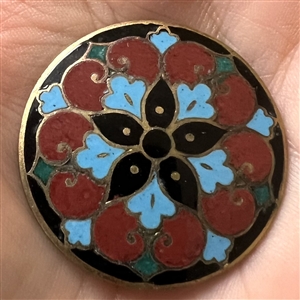 A champlevé enamel button.
