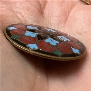 A champlevé enamel button.