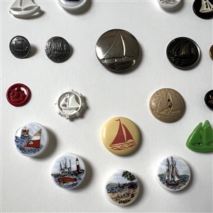 Card of twenty five sail boat buttons.
