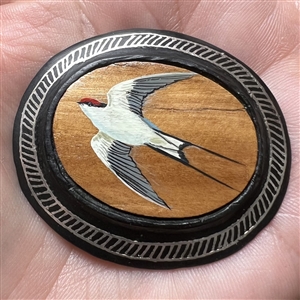 Large button of a swallow bird painted on sandalwood with metal Bidri border.