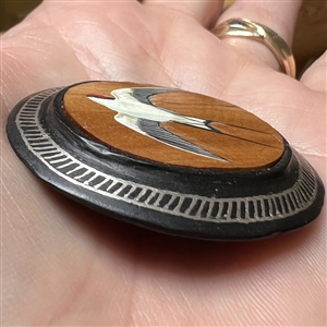 Large button of a swallow bird painted on sandalwood with metal Bidri border.