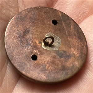 Brass button of hunter being chased by a boar.