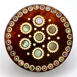 Translucent tortoise button with shell and metal inlay.