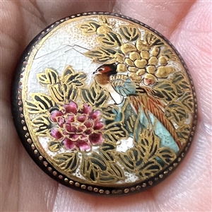 Satsuma button of a pheasant among Chrysanthemums.