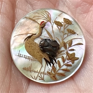 Shell button of a water bird with metal fly.