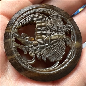 Vintage casein button of a dragon.