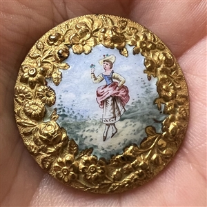 A 19th c. painted enamel button “Lady holding a sprig of flowers”