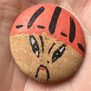 Painted silk garter button of an Asian man.