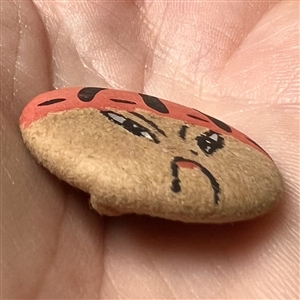 Painted silk garter button of an Asian man.