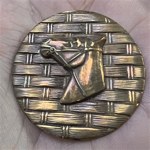 Horse head over woven background button.