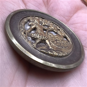 “Hoop Rolling” brass story button.
