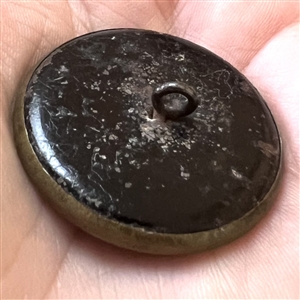 “Hoop Rolling” brass story button.