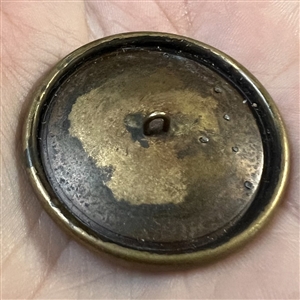 Large brass button of a head of a warrior.