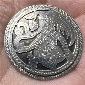 White metal button of Aztec god.