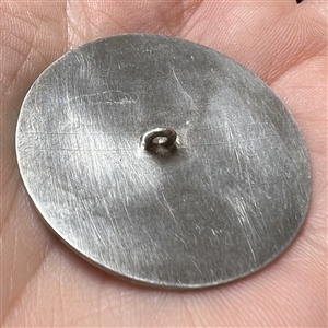White metal button of Aztec god.