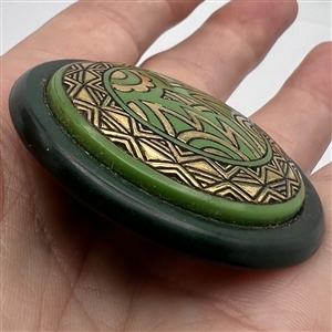 Art Deco Green glass button design set in celluloid.