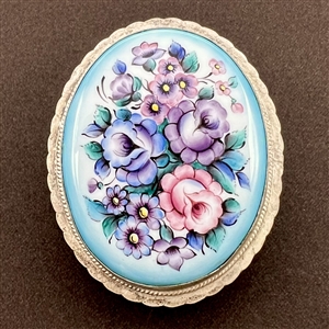 Extra large ceramic button of flowers set in metal.