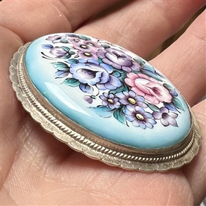 Extra large ceramic button of flowers set in metal.
