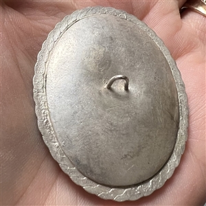 Extra large ceramic button of flowers set in metal.