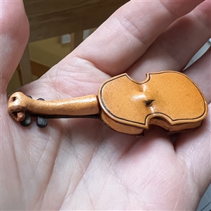 Large realistic violin leather button.