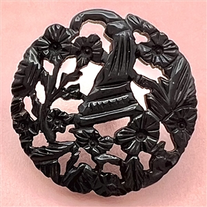 Casein button with open work of a cornucopia with flowers.