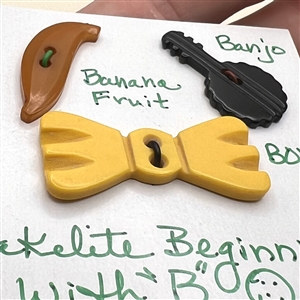 Three Vintage Bakelite buttons of objects.