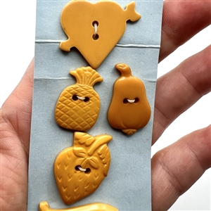 Six Vintage Bakelite buttons of assorted fruits and a heart.