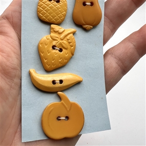 Six Vintage Bakelite buttons of assorted fruits and a heart.