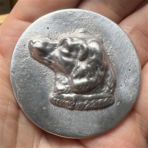 Large aluminum button of a dog head by Eutzy.