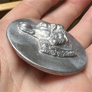 Large aluminum button of a dog head by Eutzy.