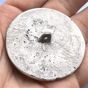 Large aluminum button of a dog head by Eutzy.