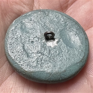Acrylic shot (?) button of a piper.