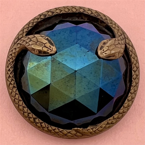 Large faceted iridescent lustered black glass with border of snakes