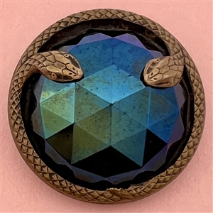 Large faceted iridescent lustered black glass with border of snakes